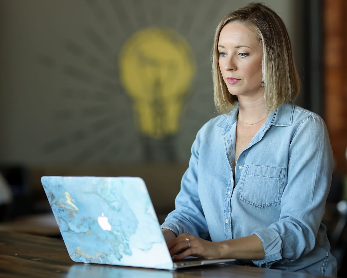 Noelle Anderson of True Blue Communications working on laptop